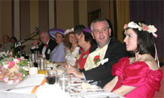 Dial M actors sitting with guests at a Dial M  murder mystery dinner